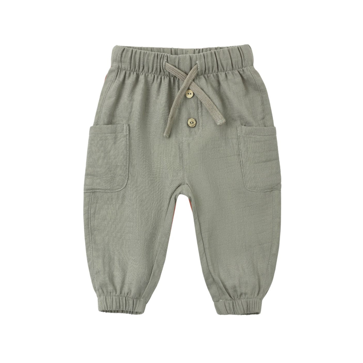 Front view of the Luca Pant - Spruce by Quincy Mae, featuring a sage green corduroy fabric, an elastic waistband with a matching adjustable drawstring, decorative front buttons, side patch pockets, and elasticized leg cuffs.