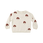 Quincy Mae long-sleeve knit sweater in a cream or parchment hue, featuring an all-over brown mushroom pattern, a round ribbed neckline, and a straight hem.