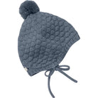 Knitted baby hat with pom-pom on a white background