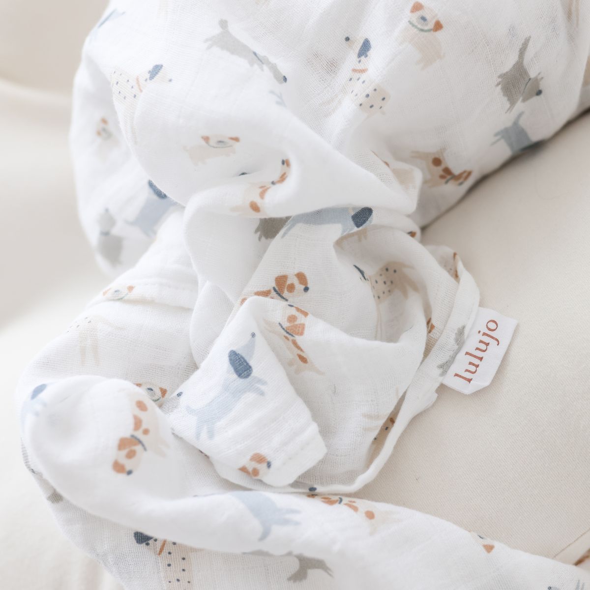 Baby blanket with animal pattern and 'lulujo' label on a light background