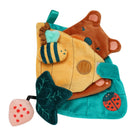 A plush sensory toy featuring a yellow fish, brown bear, teal leaf, ladybug, and strawberry, all stitched onto a teal fabric base.