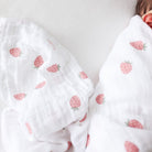 White fabric with strawberry pattern on a plain background