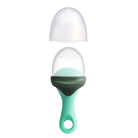 A silicone baby teether or sensory toy shown disassembled on a plain white background, featuring a mint green handle, a dark green collar, a clear dome with small raised bumps, and a translucent white cap above.