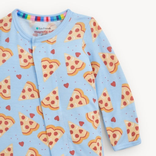 A light blue long-sleeve baby romper with an all-over print of pizza slices, red hearts, and tiny dots. The inside collar features a colorful striped trim, and the brand label reads 'eco-friendly magnetic merrow'.