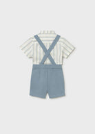 Child's outfit with striped shirt and blue suspenders on a white background