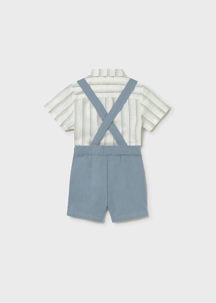 Child's outfit with striped shirt and blue suspenders on a white background