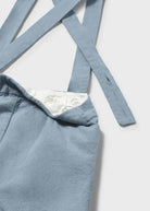 Blue pants with suspenders on a white background