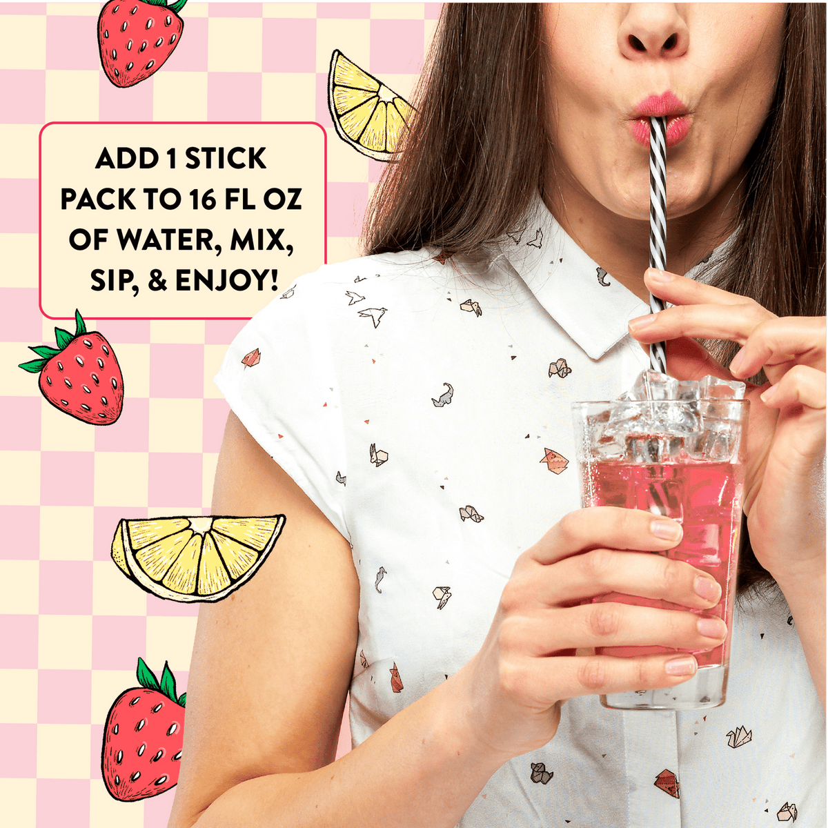 Person drinking a pink beverage with cartoon strawberries and lemons on a checkered background