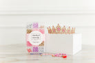Princess Party DIY Bracelet Kit featuring a compartment storage box filled with colorful beads, alphabet letter beads, and charms next to two completed pink and gold beaded bracelets, accompanied by a decorative pink-jeweled gold tiara crown.