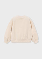 A kids' long-sleeve crewneck sweatshirt / pullover in cream.