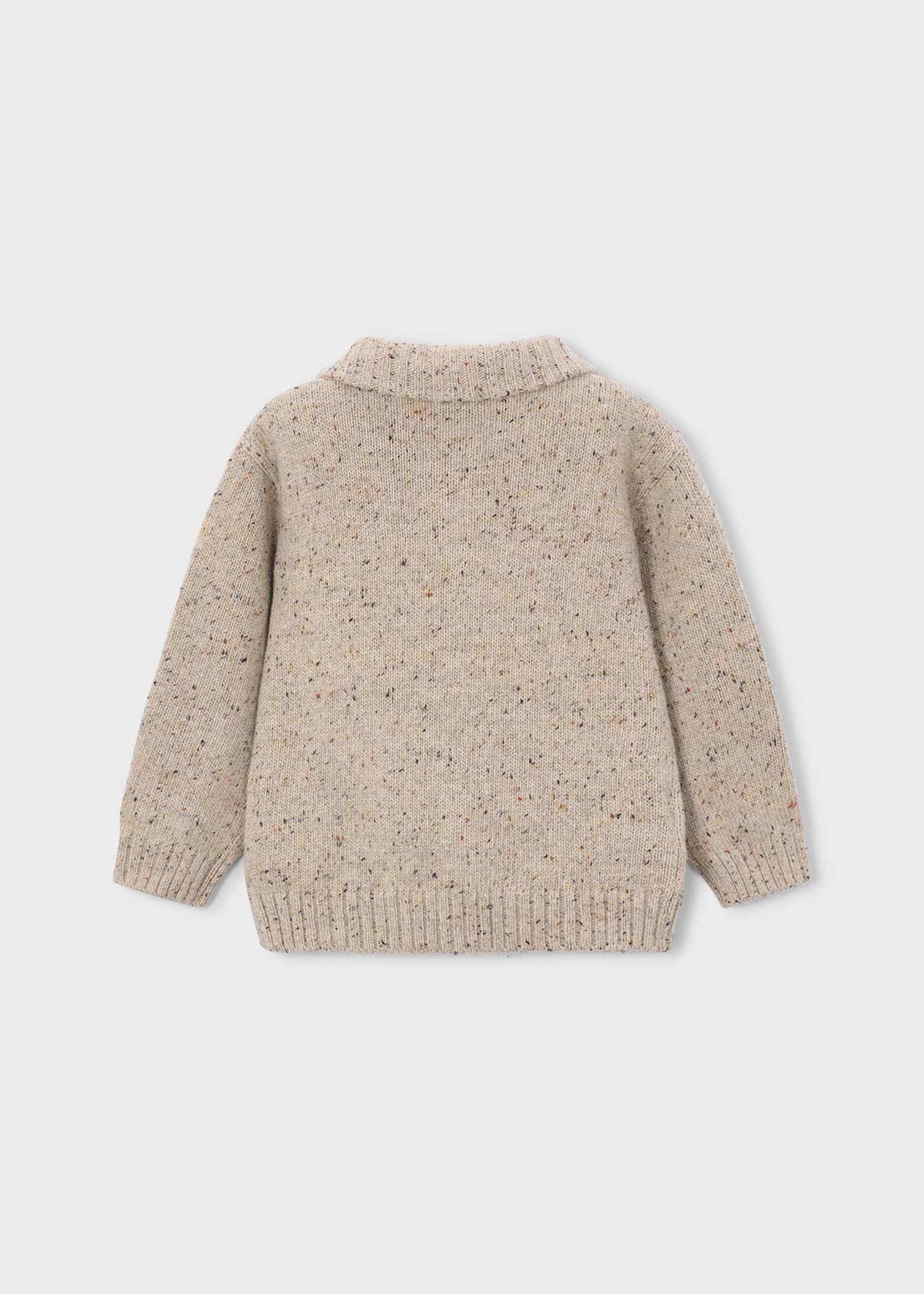 Beige knitted cardigan on a light gray background