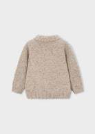 Beige knitted cardigan on a light gray background