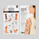 Tattly temporary tattoo sheets with dog designs and a model wearing tattoos on a gray background