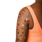 Cartoon character tattoos on a person's arm with a white background