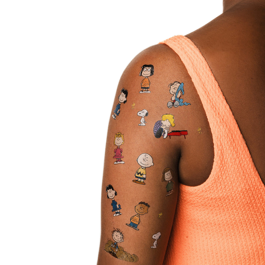 Cartoon character tattoos on a person's arm with a white background