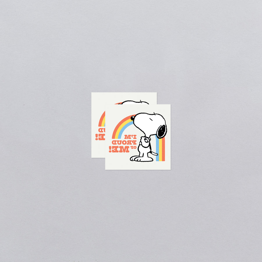 Two stickers with a cartoon dog and rainbow design on a gray background