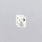 Two black and white illustrations of a dog on a gray background