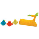 Three colorful duck-shaped toys and branch or log on a white background