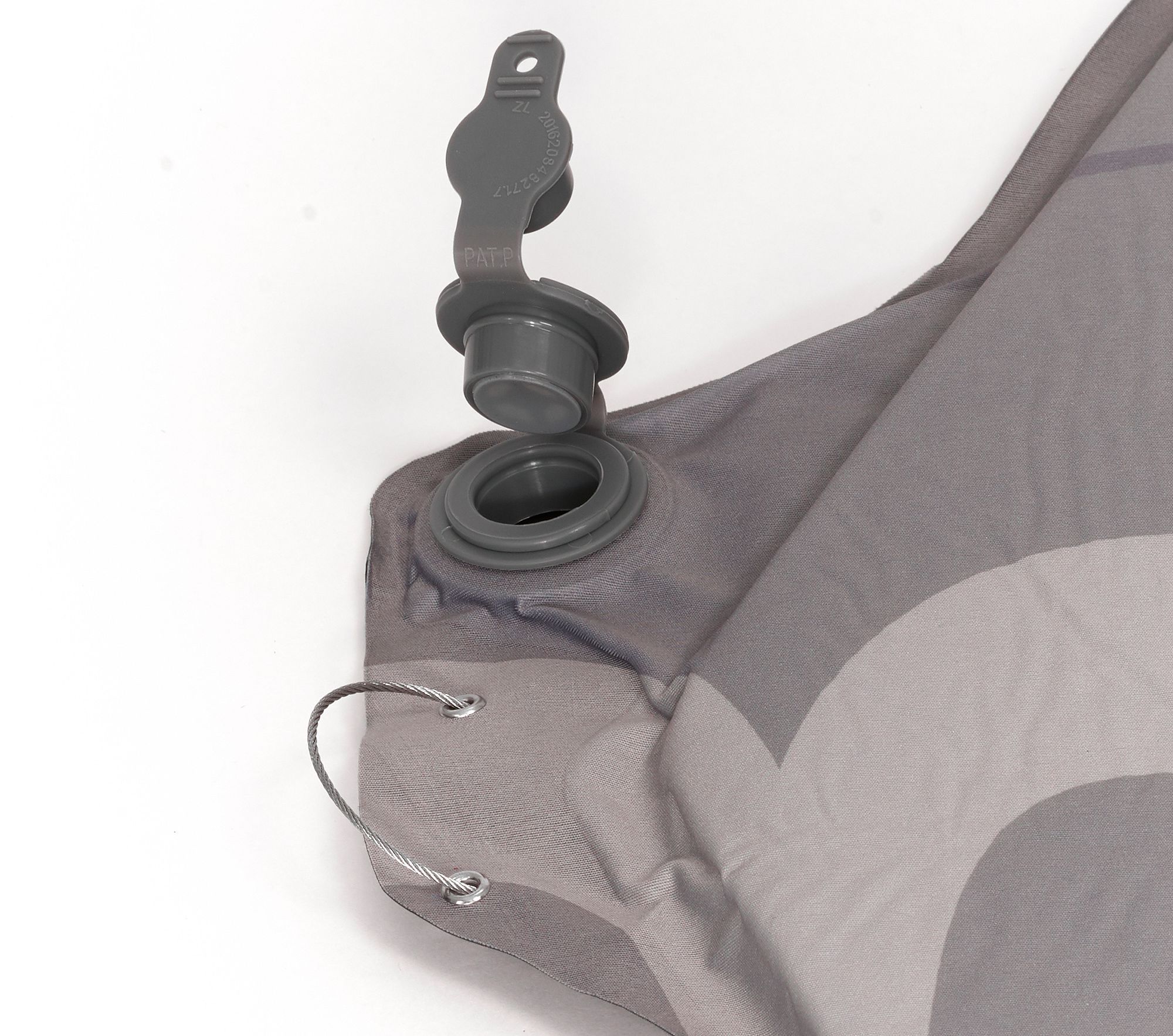 Close-up of a gray inflatable sleeping pad with valve on a white background