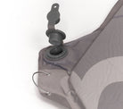 Close-up of a gray inflatable sleeping pad with valve on a white background