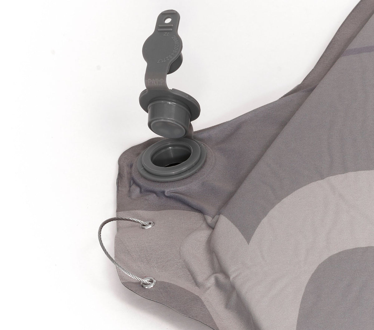 Close-up of a gray inflatable sleeping pad with valve on a white background