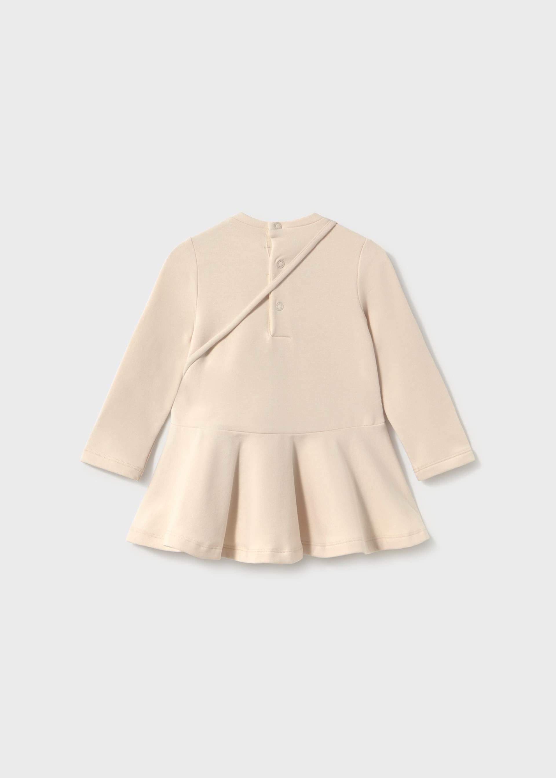 Beige peplum top on a light gray background