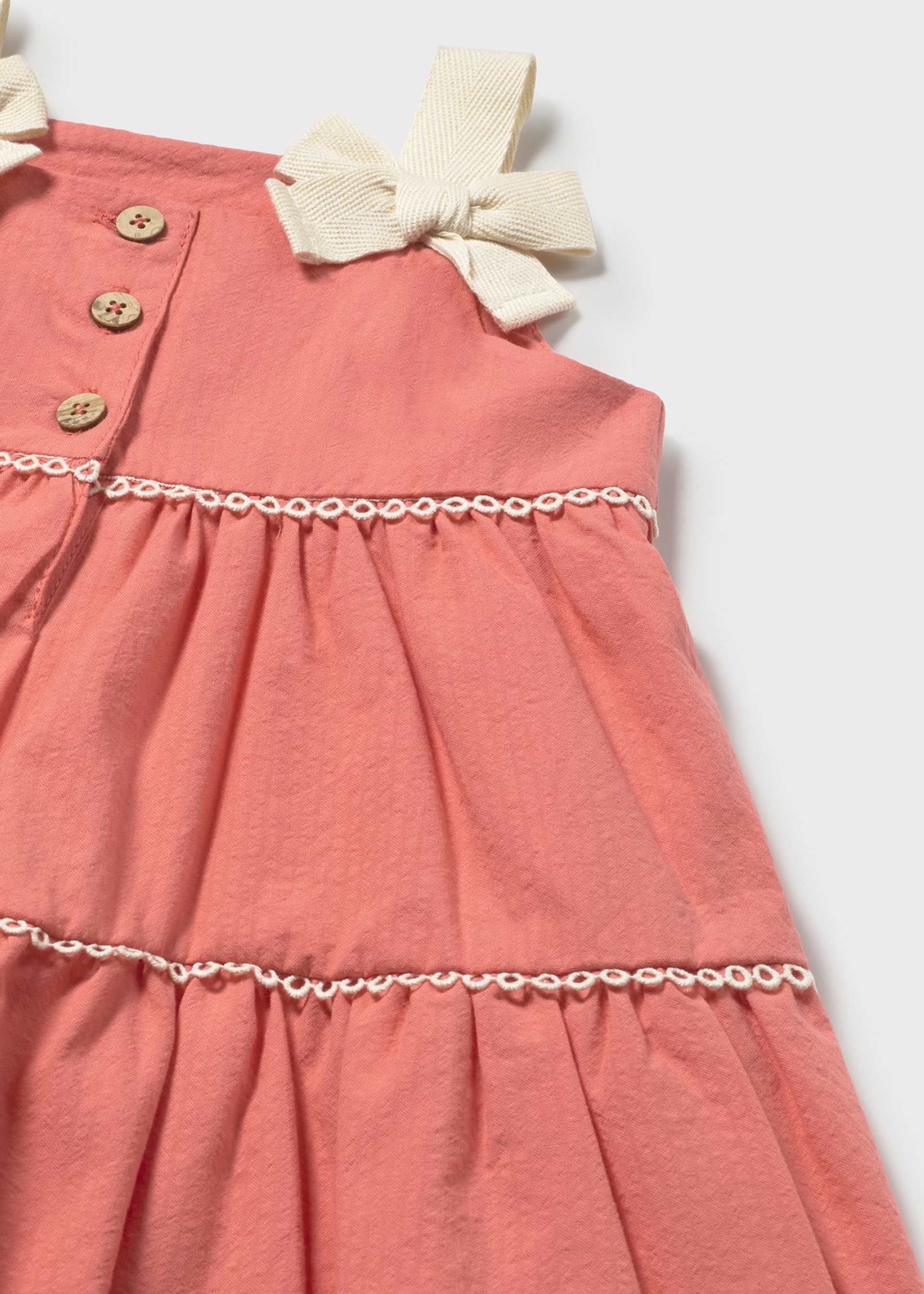 Pink dress with a bow detail on a white background
