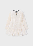 A long-sleeve, off-white sequined dress with a ruffled hem and a black neck tie, shown against a light gray background.