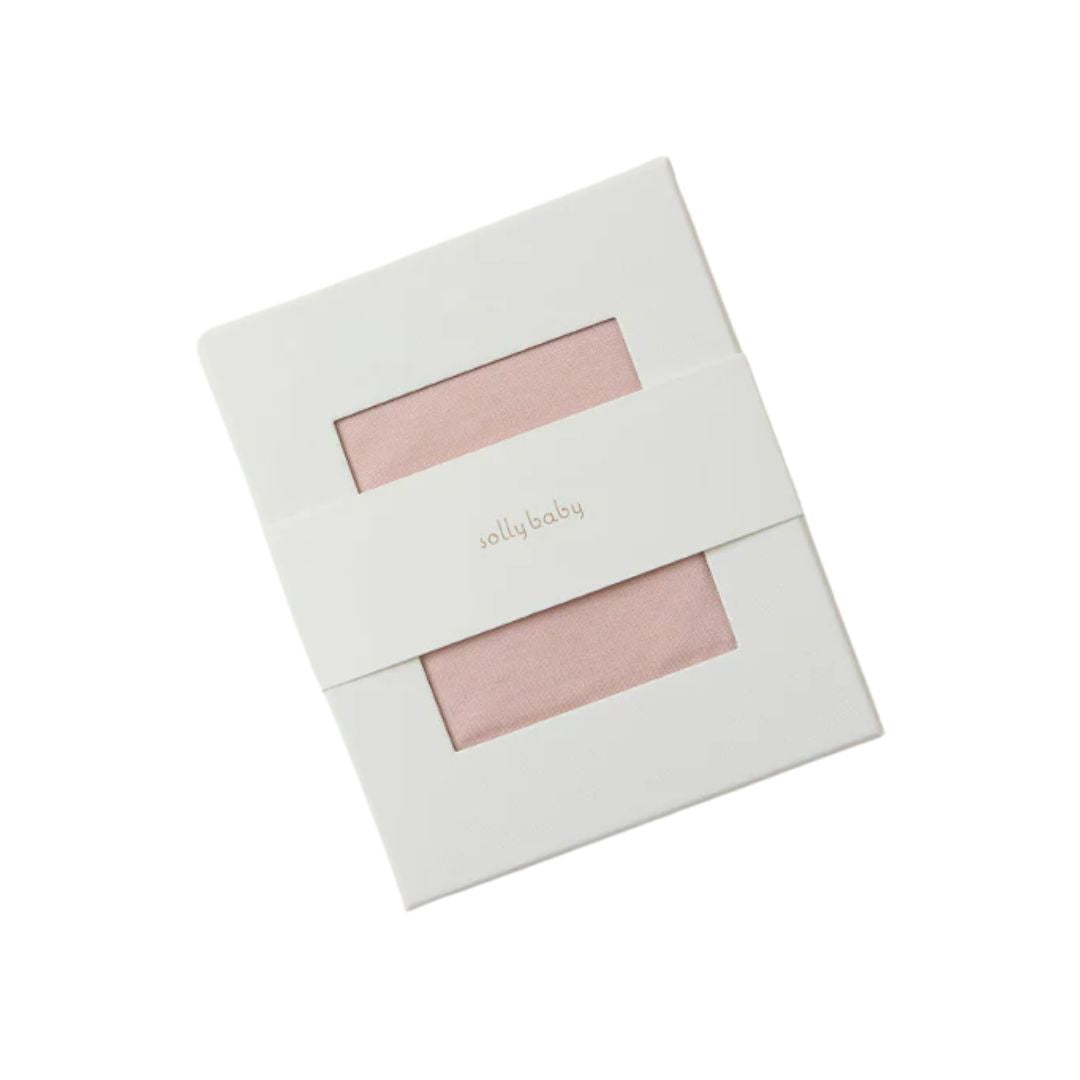 A white rectangular gift box with two horizontal cutouts showing a soft blush pink fabric inside, with the brand name 'jolly baby' printed in small gold text on the front band.
