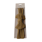 A packaged cotton tassel hair tie in a warm tan color, shown on a white background. The hair tie is knotted and displayed through a clear window in its original cardboard packaging.