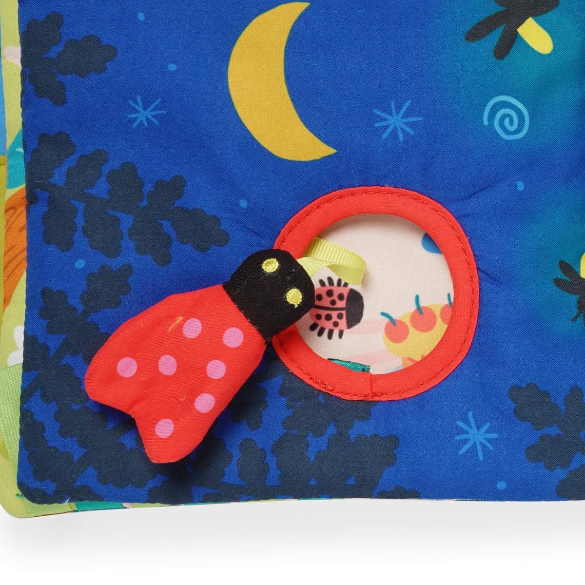 Children's soft book with ladybug and moon design on a blue background