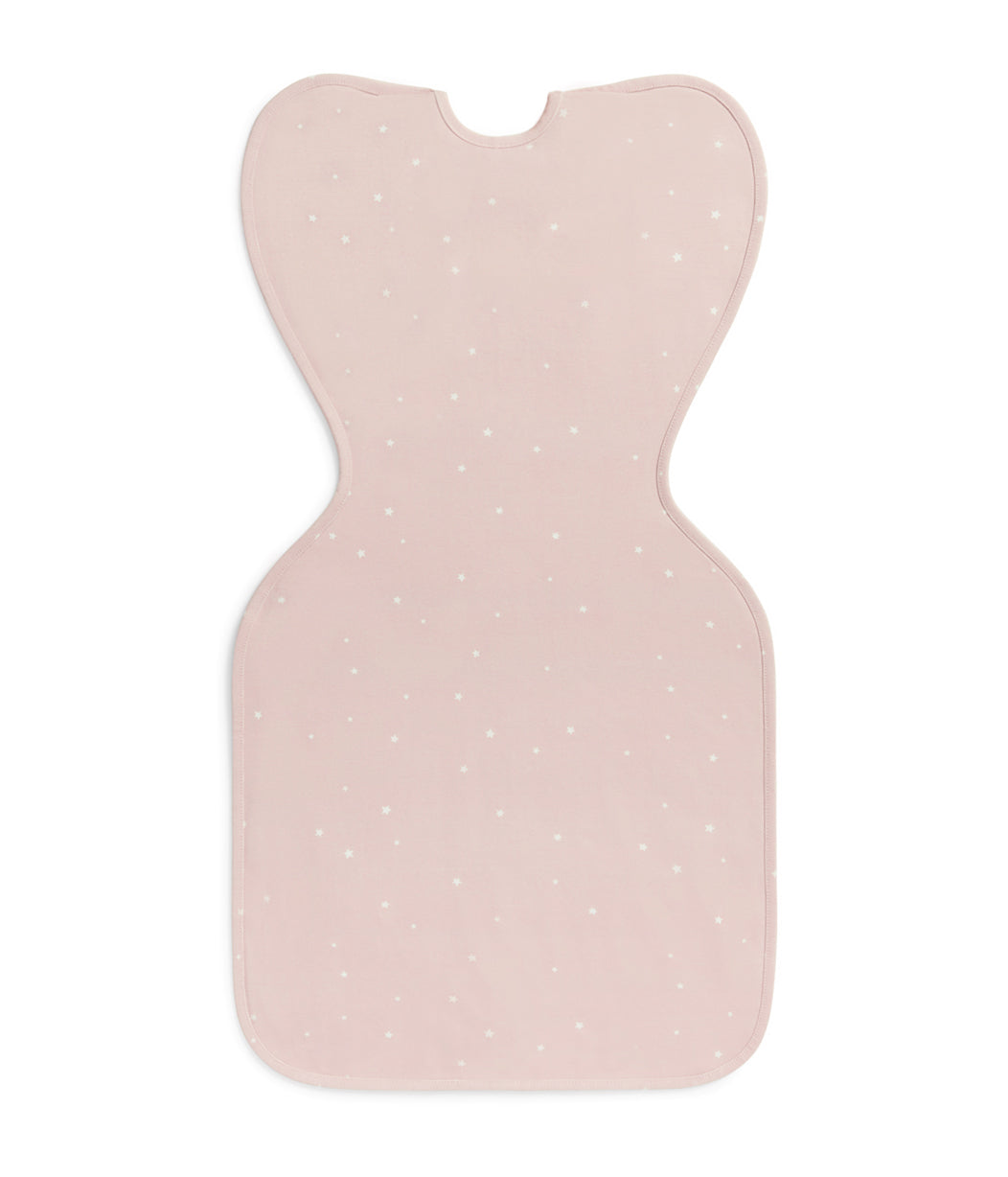 Pink baby car seat cover with white polka dots on a white background