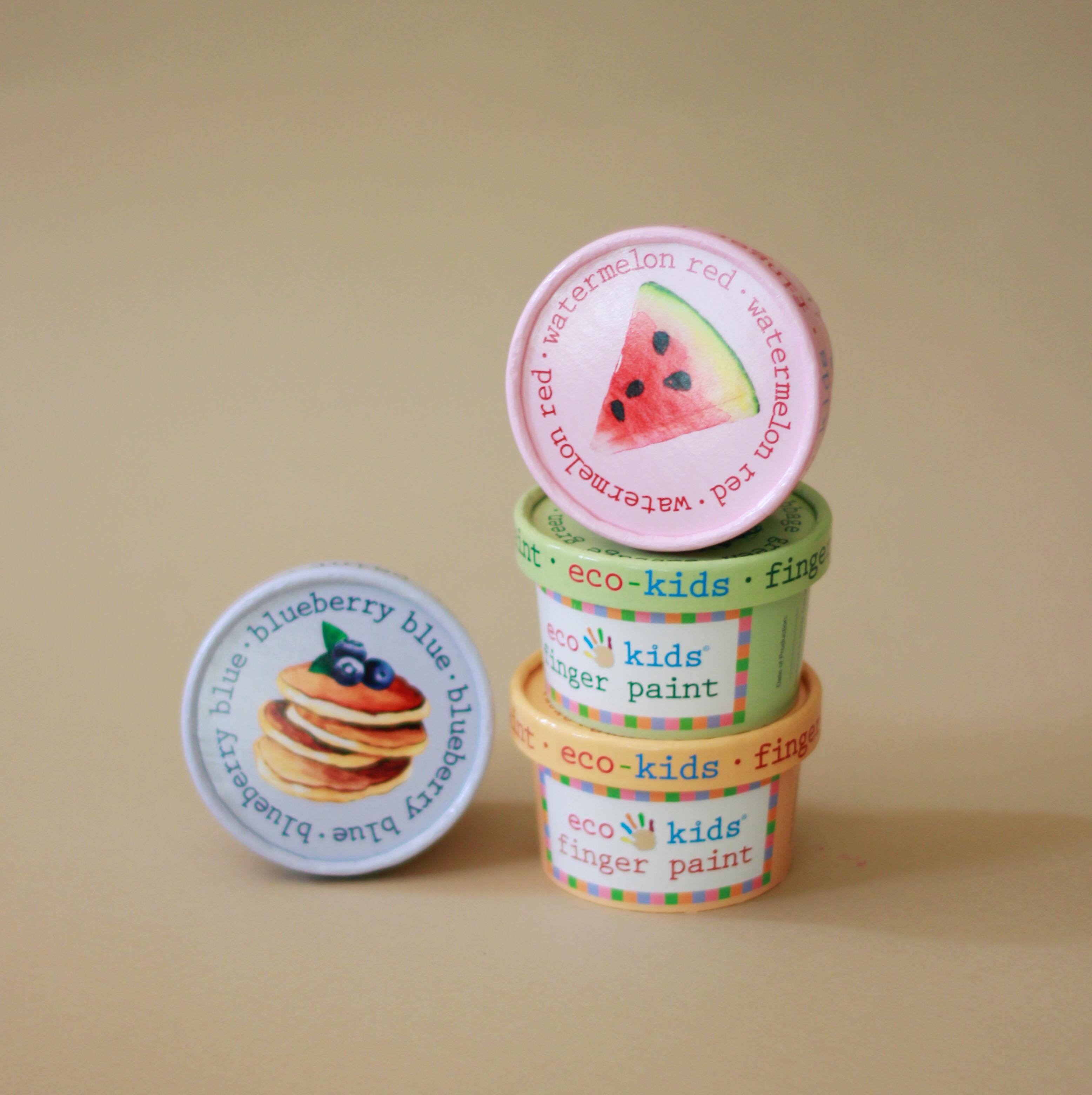 Set of eco kids finger paint containers with colorful lids on a beige background