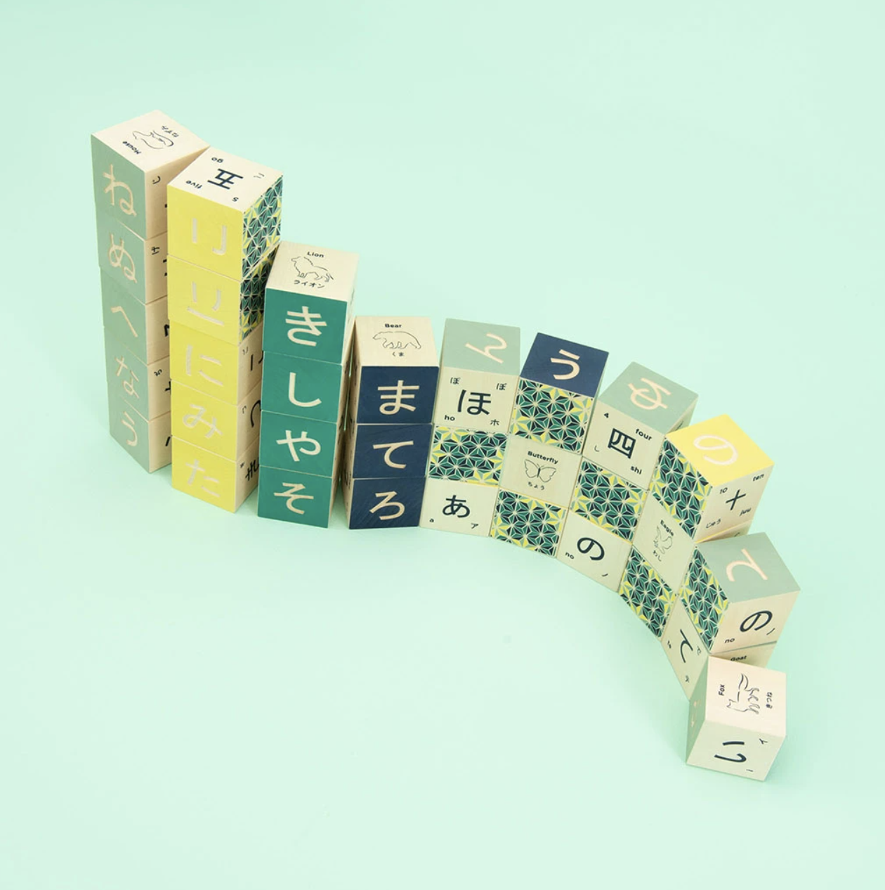Colorful wooden blocks with Japanese text and patterns on a green background
